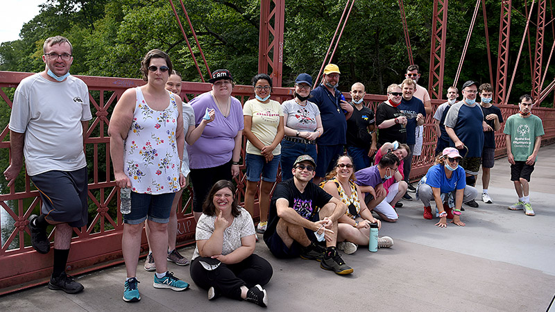 Outdoor photo of a group of people on a bridge